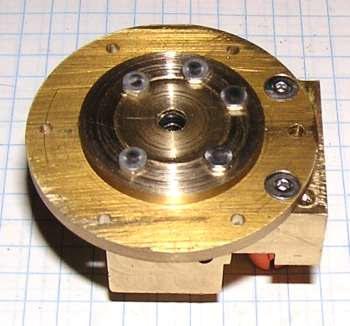 This is the underside of the head with all the parts screwed together. The hex head screws retain the washer in the the disk and hold the disk to the head and the head to the block.