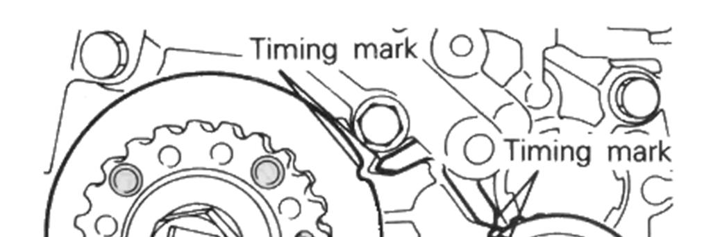 camshaft sprocket timing marks should be in line with the top surface of the cylinder head