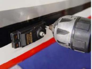 Install servos as shown with the servo label facing the rear of the fuselage.