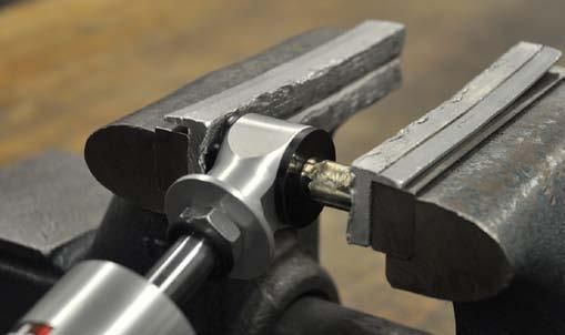 Press the steel sleeve into the bushings, using a vise or press. 15.