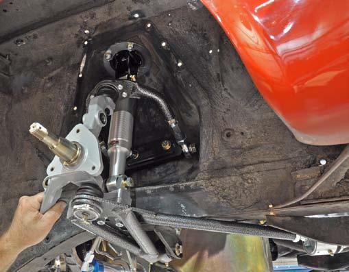 22. Using a jack placed under the lower control arm, raise the suspension to its ride-height position.
