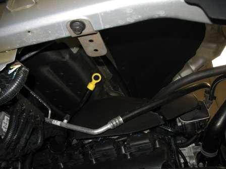 d. Install the bottom heat shield bracket under the passenger side