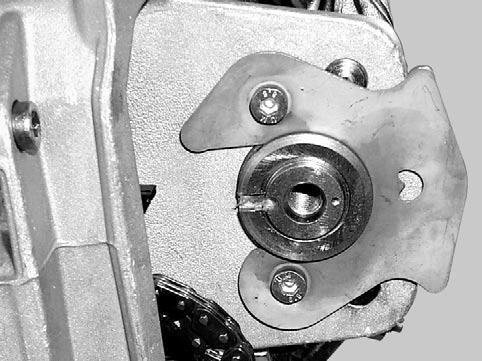 Install camshaft timing gear so that the timing gear tab is located into the camshaft groove. The pointed end of camshaft retaining plate should be visible by the top hole.