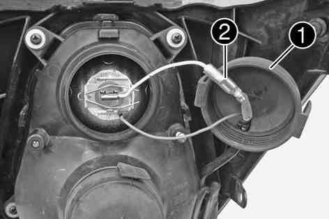 ELECTRICAL SYSTEM 136 Remove rubber cap and disconnect plug-in connector. 100594-10 Detach spring bar and remove the bulb from the headlight.