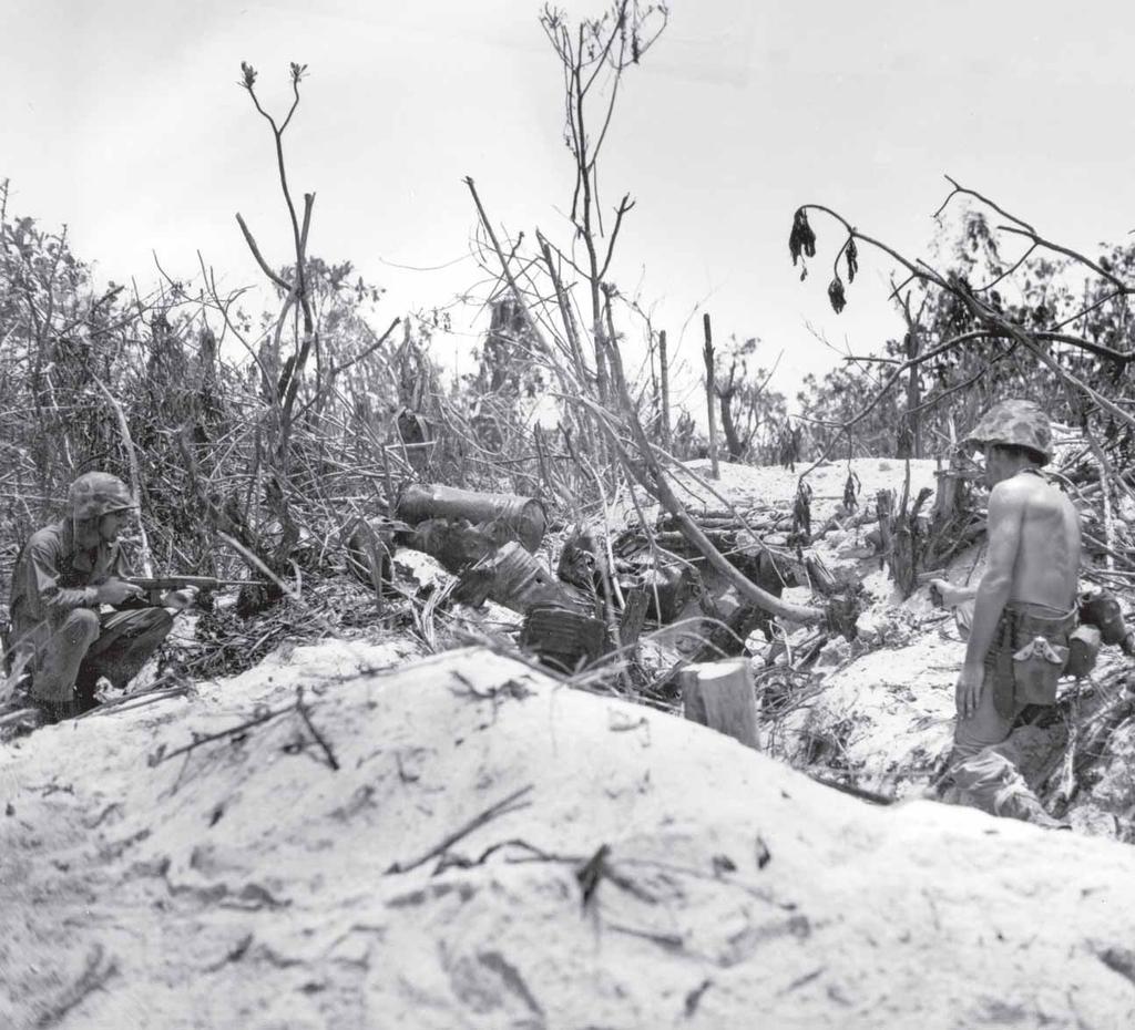 Marines advance to within feet of an occupied pillbox.