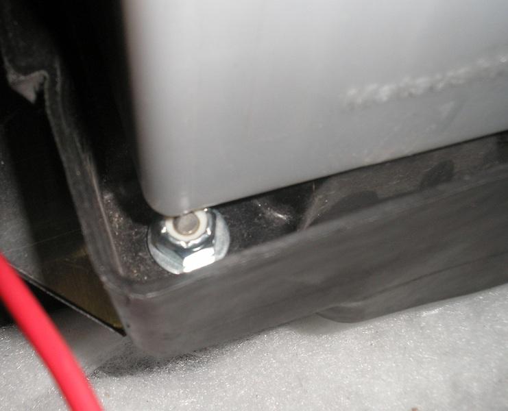 You will notice that the slotted part of the mounting tray is resting on a stock fastener.