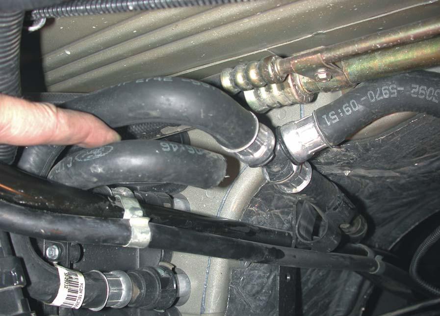 1.2.4 2003 Models Heater Hoses Document 1930054 1. Remove the heater hoses from the plastic retainer clip (Figure 1.7).