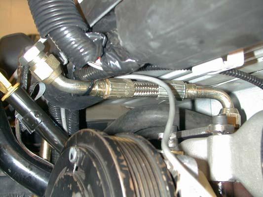 11. Fit the supplied 28 x 5/8 inch heater hose to the other end of the lower heater hose connector and route the hose over the inlet valve to the connector installed earlier at the heater core end.