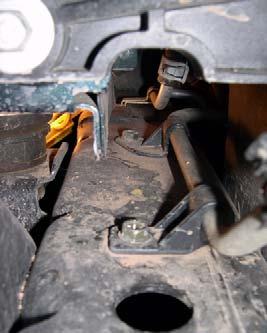 c. Remove two bolts and transmission cooler line