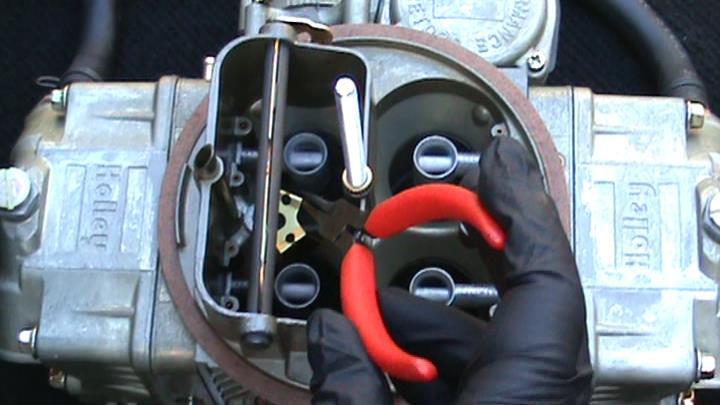6. With the needle nose pliers, slide the POWERBLAST PLATE under the choke plate and over the nozzle mounting pedestal.