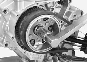 ALTERNATOR/STARTER CLUTCH Apply engine oil to the flywheel nut threads and seating surface. Install the washer and flywheel nut.