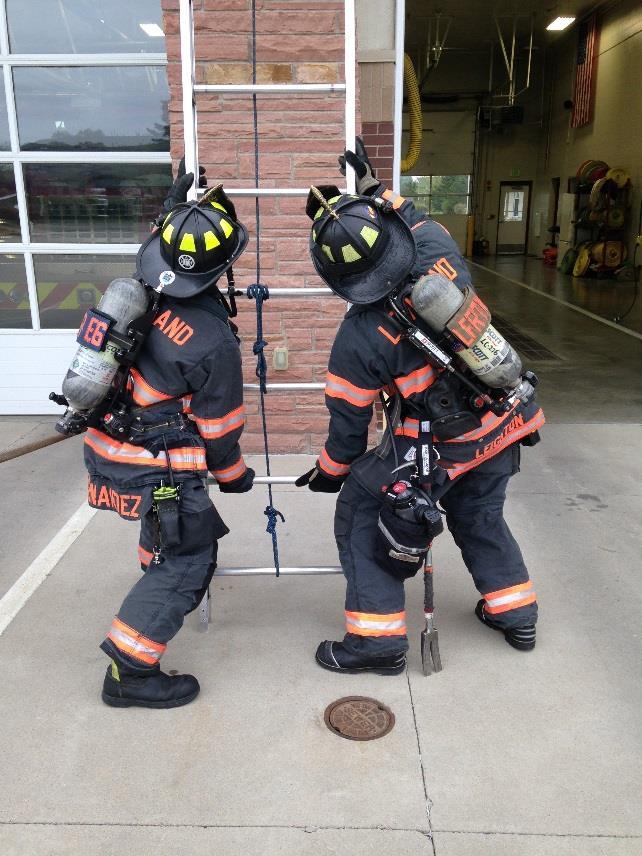 #9 If necessary, this is an example of two firefighters adjusting the ladder for proper placement and climbing angle.