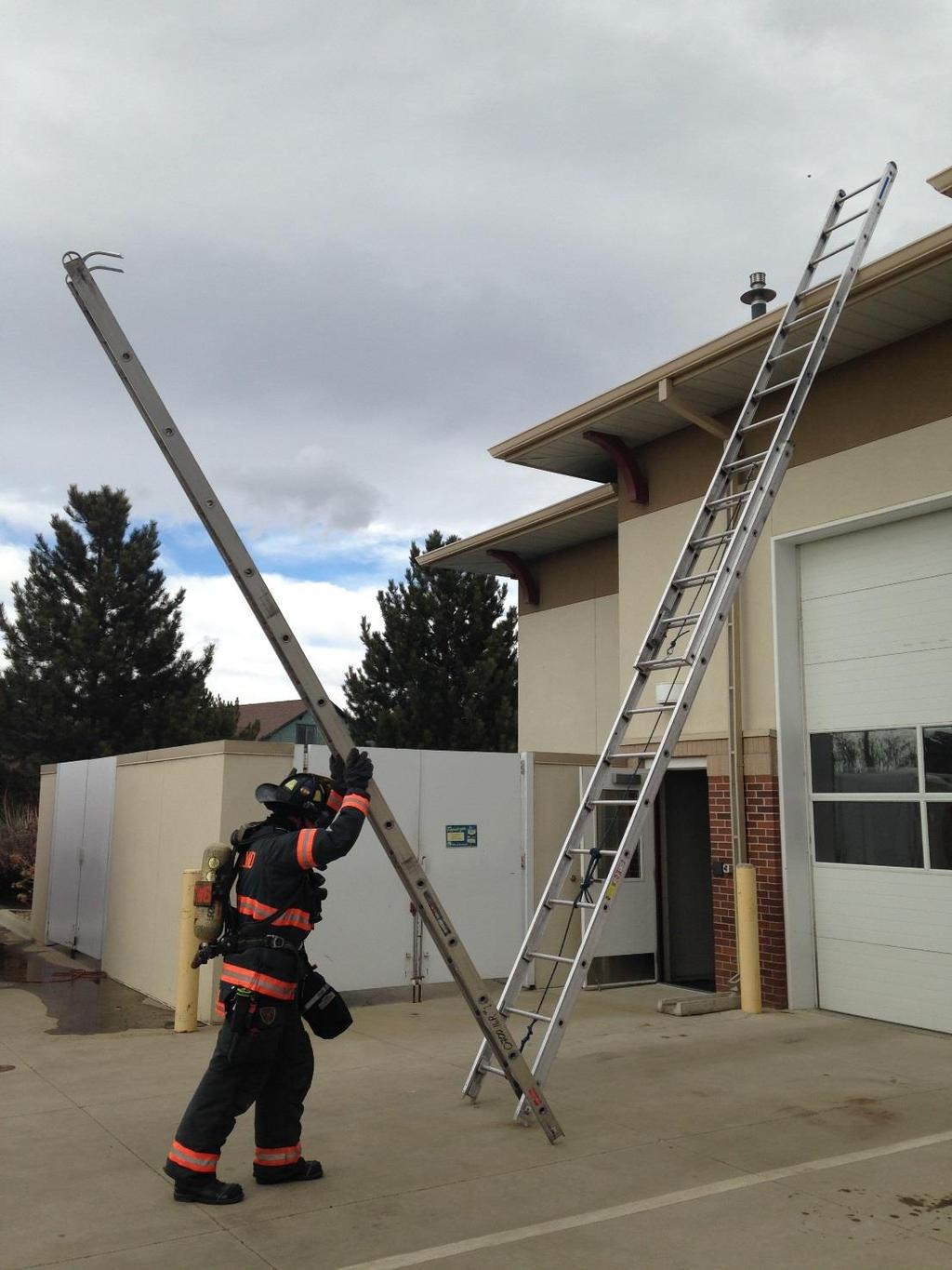 #12 Place the lowest rung of the ladder into the extension ladder already placed on the building using it as a pivot point and