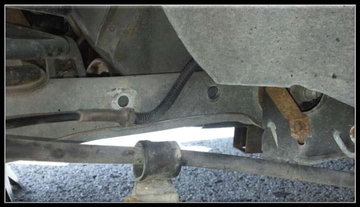 The bolts were in the two holes shown below and are ½ inch in size. *Note: it would be easier to do this with someone holding the sway bar while you loosen it up. 4.
