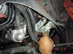 Install new power steering bracket to valve cover using the