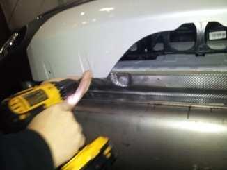3. Underneath the vehicle, remove the 4 screws securing the center