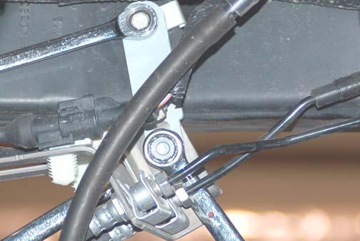 Remove rear shocks from the upper and lower mount using 18mm and a 15mm wrench. See Photo 1 & 2. Retain the stock hardware.