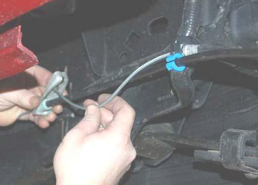 Using a 10mm wrench, remove the brake line assembly on the inner driver side frame rail. See Photo 3. 5.