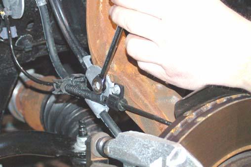 Remove the ABS and brake line bracket from the knuckle using a 8mm wrench for the ABS wire and a 10mm wrench for the brake line bracket. Retain hardware for reuse.