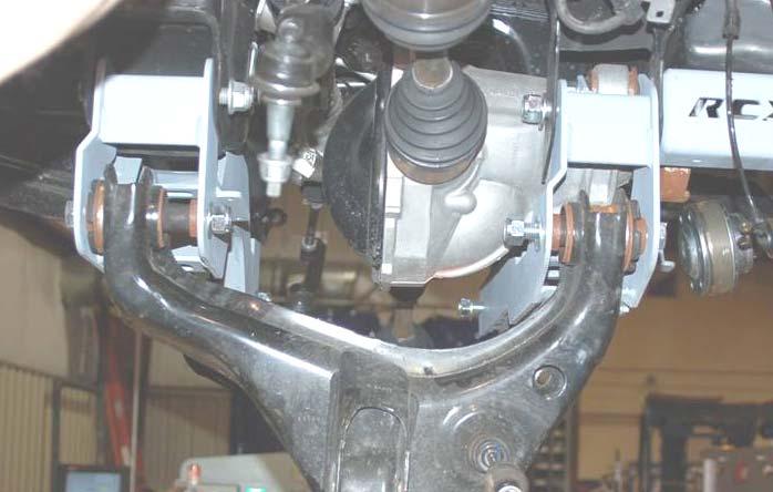 37. Reinstall the vent tube on the differential. 38. Install the front cross-member using the factory hardware. See Photo 31. Do not tighten at this time. 39.