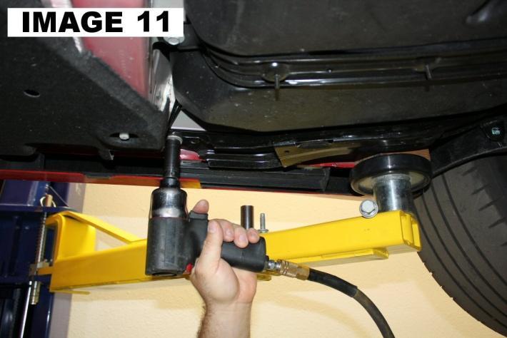 12. Place the hydraulic jack under the cradle. Using a 15mm socket, remove the two front bolts on the cradle braces as shown in IMAGE 11. Using an 18mm socket, remove the front main cradle bolts. 13.