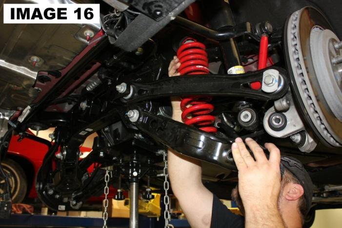 Using a jack, lift the control arm back up into place and re-insert the outer bolt. Tighten the bolt to 130 ft/lbs.