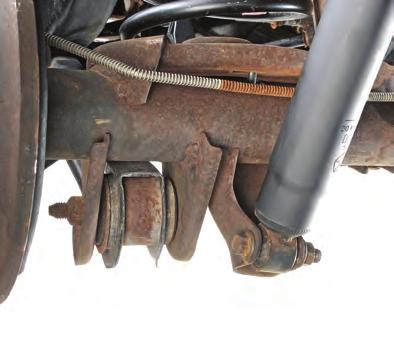 Locate rear axle track bar mount and removed plastic cover (see FIG 19) and discard.