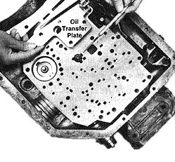 7) (Note: Slot in transfer plate lines up with two holes in the separator plate and creates a new oil circuit.) Install support plate bolts finger tight. Remove center pan bolt.