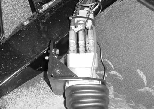 Loader Float Magnet Removal and Installation Figure 9-4 8. Pull the joystick away from the cab wall as shown.