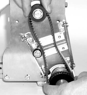 Depending on conveyor belt travel (direction 1 or 2 of Figure 8), locate timing belt tensioner (AH), as shown. Do not tighten tensioner screw.