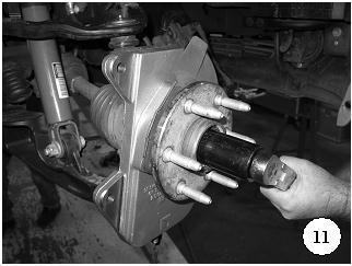 c) Tighten the upper ball joint nut in place and torque to 37 ft-lbs. d) Tighten the lower ball joint (Photo 9).