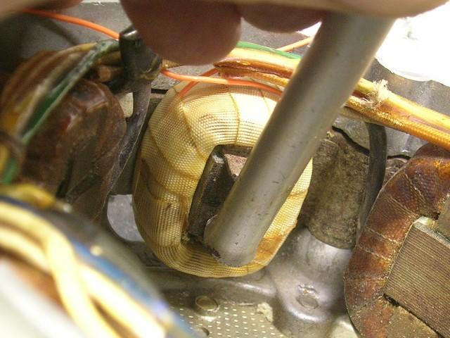 Electrically, it does not matter which side of the coil faces outward, but try to choose the side that won't alow the end of the wrap to catch on the iron as
