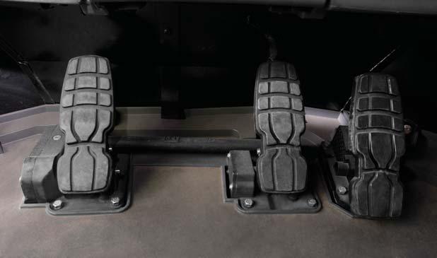 Decelerator Pedal The left pedal acts as a brake, transmission neutralizer and an engine decelerator to override the engine speed selected by the throttle lock.
