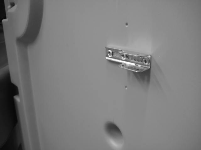 Install Door Closure / Door closure cover: 46) Place door closure bracket PN 47) Drill out (2) dimples on inside of door 21382 on facing inside of