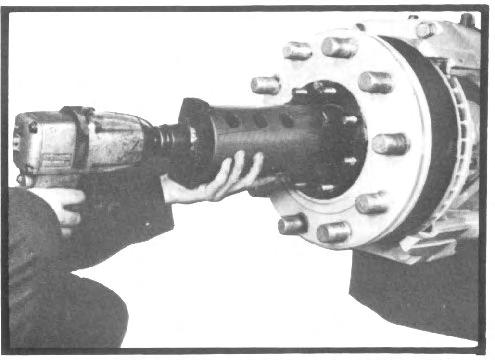 Remove the yoke shaft retaining locknut from the center of the yoke shaft retaining cap. Early axles were equipped with a capscrew that retained the yoke shaft.