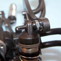 H8) Slide the bushings over the upper shock mounting bolts so