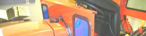 See fig. 3.2. With assistance, place the hard rear panel on the tractor in front of the R.O.P.S. tubing oriented as shown with the window towards the rear.