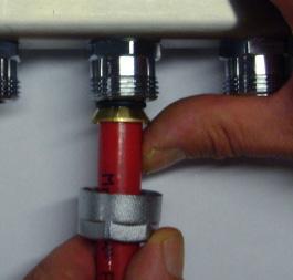 Start by making a square cut at the end of the tube even with the bottom of the manifold outlet nipple (without the fitting) using a suitable tubing cutter.