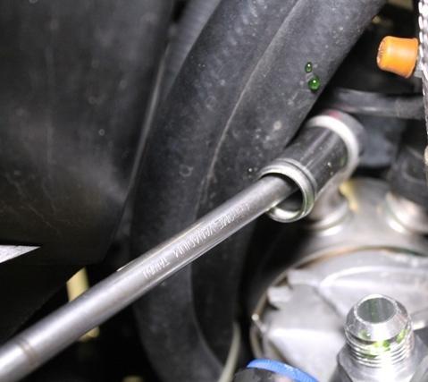 Page9 16. Using a pair of pliers, remove the clamp securing the coolant hose leading to the OEM oil cooler.