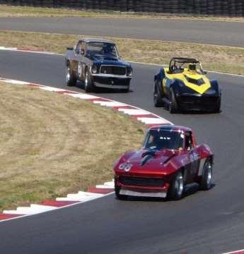 Classic battle between Triumph TR6 and Datsun 240Z in mid-bore race.