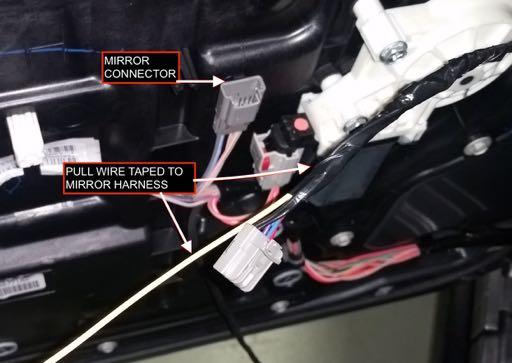 6. With the door panel removed, unplug the mirror harness and connect a pull wire to