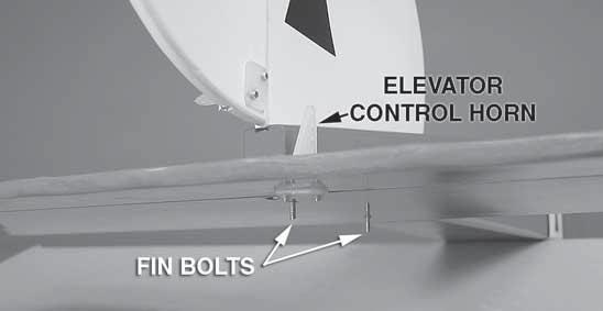 Insert the vertical fin/rudder assembly into the slot so that the two fi n bolts protrude through the