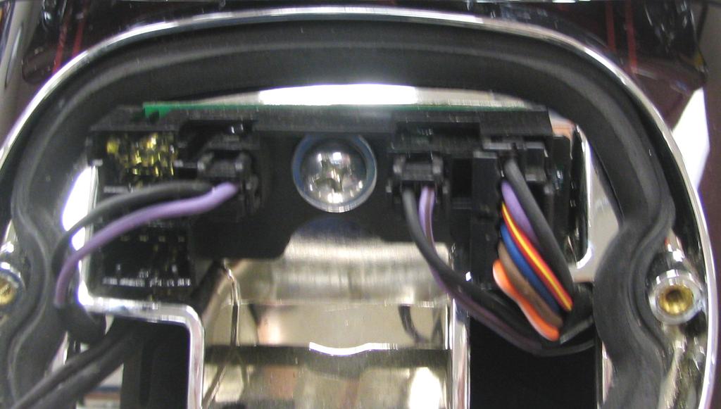 Cut the connectors off the license plate light wires. Strip about 1/2 of the insulation from the wires and install one of the supplied male spade connectors to each RED wire.
