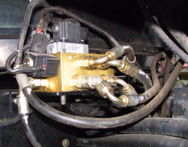 Remove the right and left steering hoses from the tractor steering unit (Orbitrol).