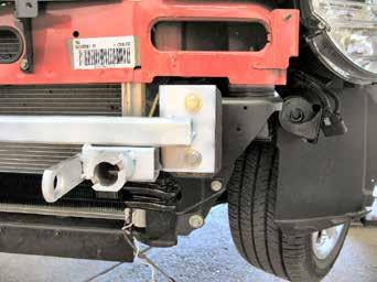 8 8. Using a 15MM socket, remove two metric bolts from the metal bumper. Do this to both sides of the vehicle. Pull metal bumper forward and set aside with the bolts to be reinstalled later. 9.