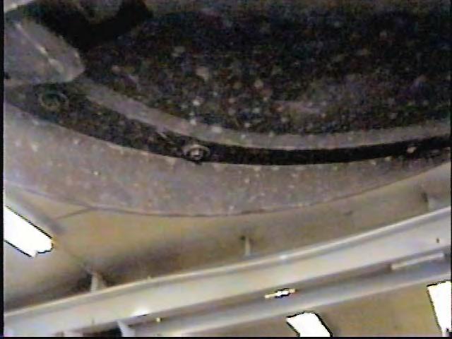 3. Using the 6MM socket, remove three metric bolts, just forward of the front tire.