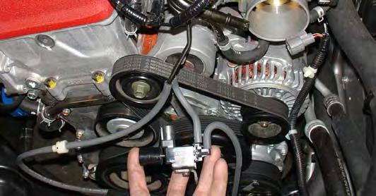 Unclip the wire harness clip, unclip the check valve vacuum line (C) and unscrew the m6