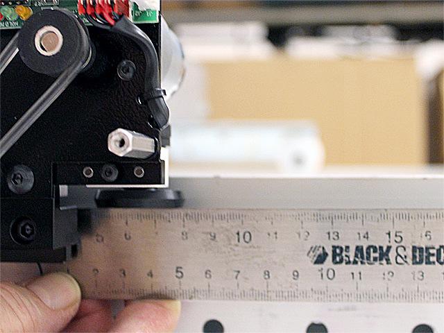 Hold a long ruler at the sensor wheel s side and adjust the bracket with screws A and B until the