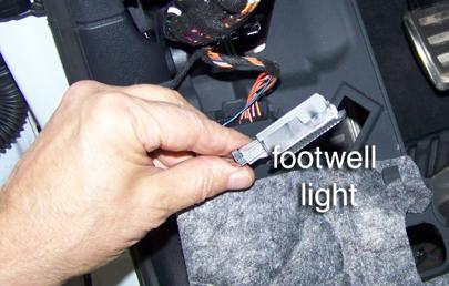 When the tabs clear the dash, drop the dash panel down into the driver side footwell. Step 4 Remove the footwell light.