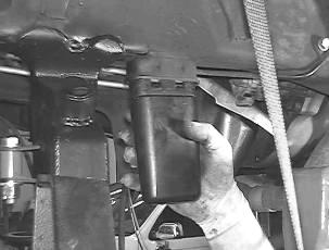 16. Slide one of the upper link arms into the new upper link arm mount on the front axle with the barrel gussets facing down and into the original upper mount on the